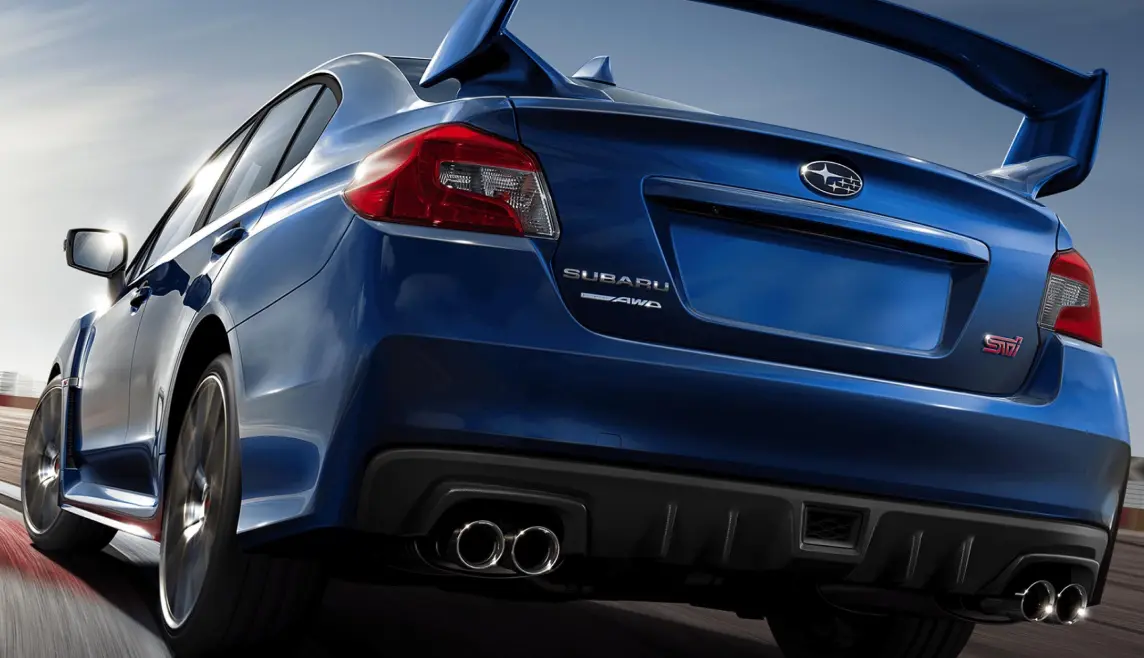 Close-up of a WRX Subaru leaning into a turn, viewed from behind.
