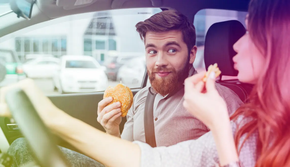 Image of people eating in car