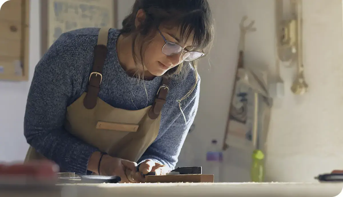 Image of woman leather-working