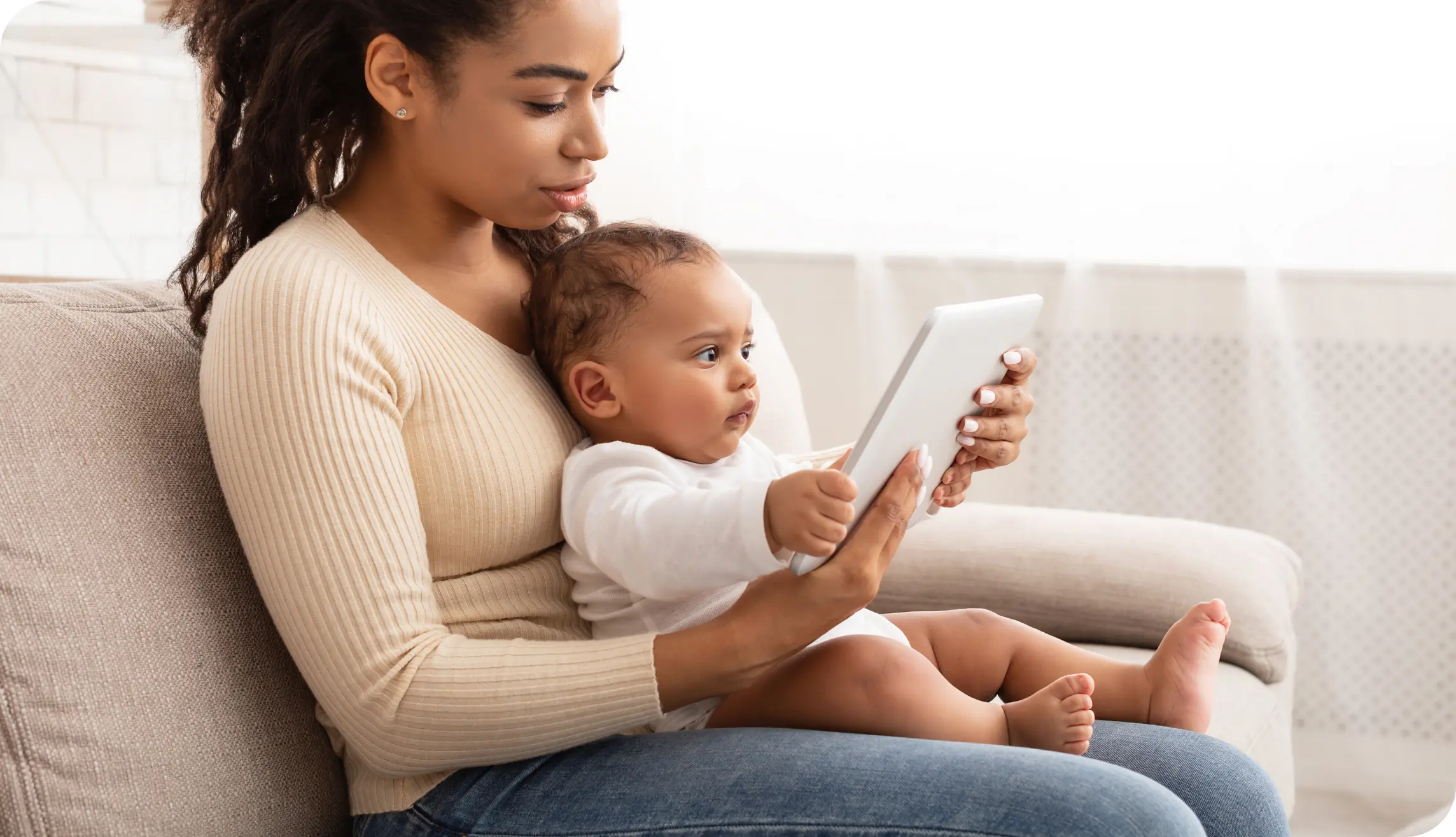Mother and baby holding a tablet