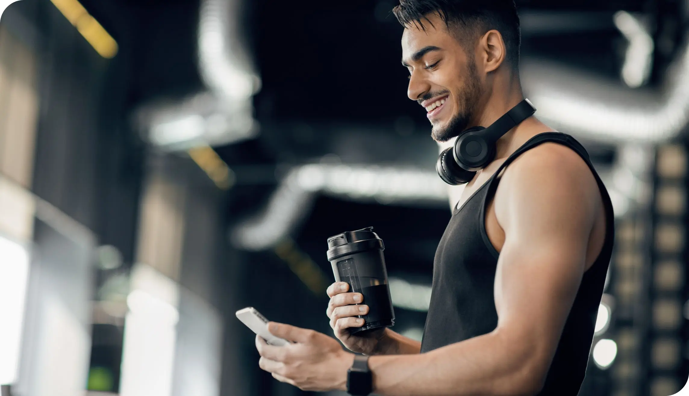 Image of man in workout gear checking mobile phone